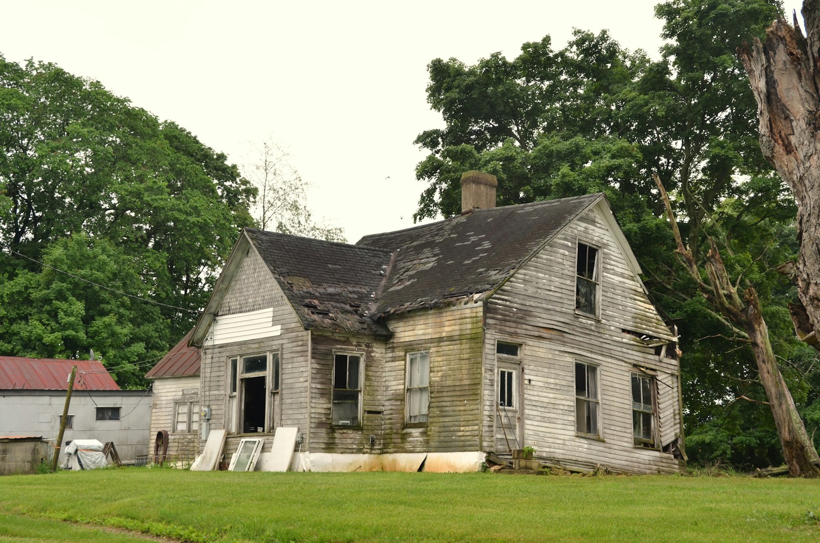 Before — dilapidated wooden farmhouse